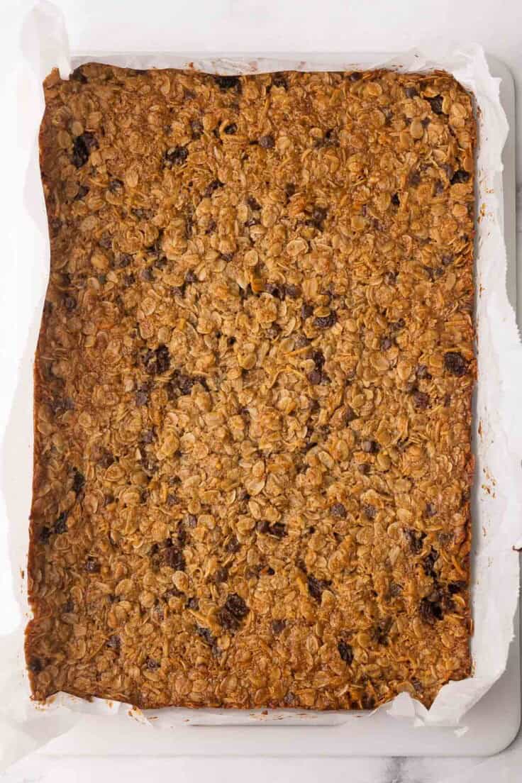 baked peanut butter granola bars uncut on parchment.