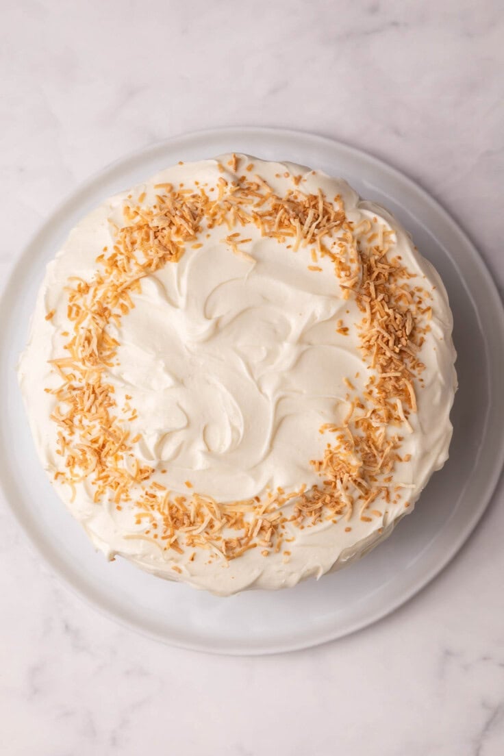 overhead view of pineapple coconut cake frosted.