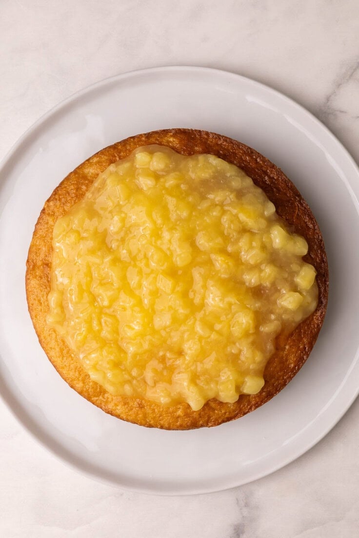 pineapple layer spread on top of first cake layer.