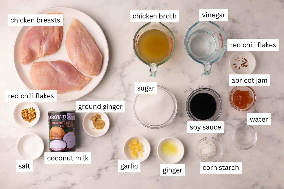 Slow Cooker Coconut Chicken cooks up tender in creamy coconut milk, then gets tossed in a sticky sweet-heat sauce. Serve it over rice or noodles for a bold, easy dinner! #slowcooker #dinner #recipe | chicken recipes | chicken breast | chicken dinner | dinner ideas | dinner recipes | slow cooker meals | crockpot chicken | easy dinners ingredients for sweet and spicy coconut chicken in bowls and plate.