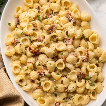 sun dried tomato pasta topped with chopped parsley.
