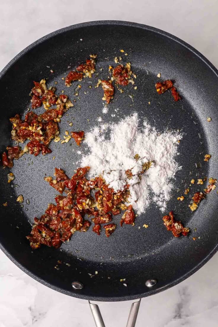 flour added to black pan with other ingredients.