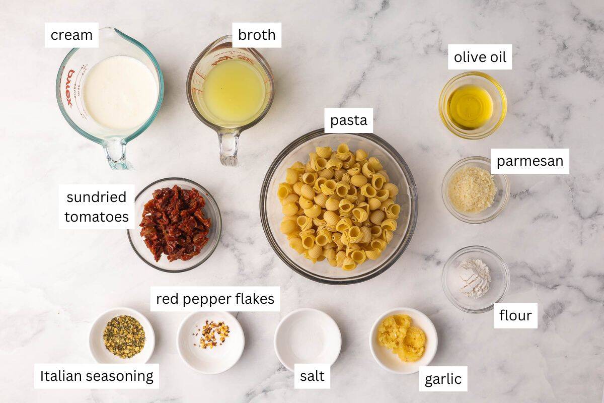 Sun Dried Tomato Pasta is a quick, creamy pasta dinner with garlic, Parmesan, and lots of sun dried tomato flavor. It's easy enough for weeknights and ready in 20 minutes! #pasta #dinner #recipe | easy pasta recipe | dinner ideas | sun dried tomatoes | sundried tomatoes | comfort food | dinner party ingredients needed for sundried tomato pasta in bowls.