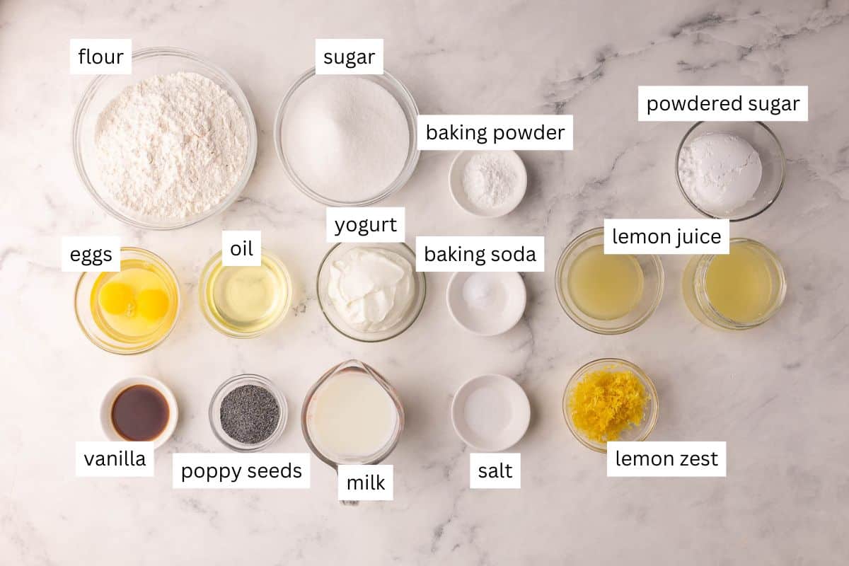 These fluffy Lemon Poppy Seed Muffins are light, zesty, and bakery-soft! Made with Greek yogurt for moisture and finished with a bright lemon glaze. #baking #recipe | muffin recipes | lemon recipes | baking from scratch | breakfast ideas | healthy snacks ingredients needed for lemon poppy seed muffins on a white background.