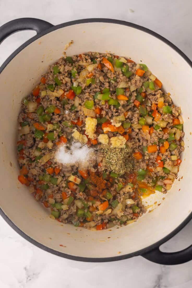 spices added to large pot with other ingredients.
