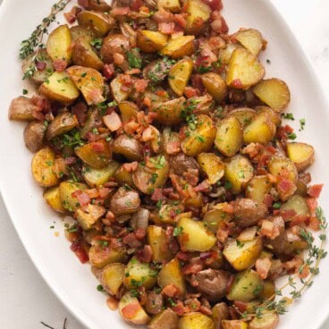 large white platter filled with maple bacon potato salad.