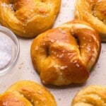 close up of a soft pretzel with others beside.