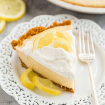 square image of a slice of lemon icebox pie on a white plate with whipped cream.