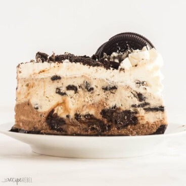 square image of slice of oreo ice cream cake on white plate.