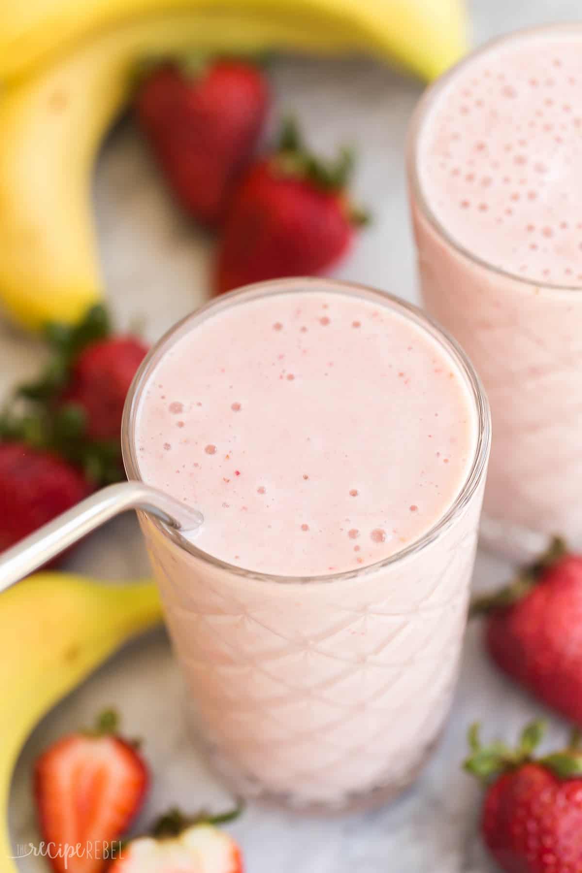This healthy Strawberry Banana Smoothie recipe is easy to make and great for a weekday breakfast! Made with four ingredients, it's healthy and a good source of protein. #smoothie #recipe #breakfast | healthy recipes | healthy smoothies | smoothie recipe | breakfast smoothie | fruit smoothie | strawberry smoothie | frozen bananas | frozen fruit | healthy breakfast close up overhead image of a strawberry banana smoothie with a straw.