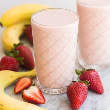strawberry banana smoothie in a tall textured glass.