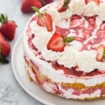 square image of whole strawberry shortcake ice cream cake on a white plate.