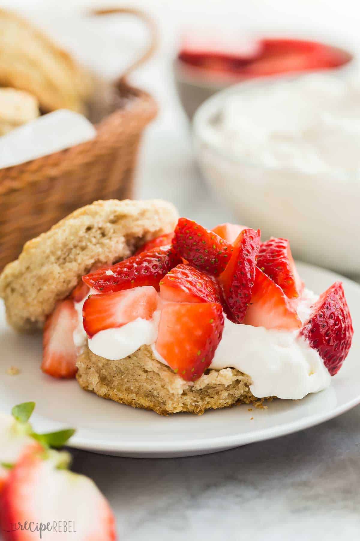 This Strawberry Shortcake recipe is made completely from scratch, but make ahead and freezer options make this an easy strawberry dessert you'll enjoy all summer long! With flaky biscuits, fresh strawberries and homemade whipped cream. #strawberry #dessert #recipe | dessert recipes | easy desserts | summer dessert | strawberry recipes | dessert recipes | baking from scratch | homemade whipped cream | make ahead biscuit with whipped cream and fresh strawberries to make strawberry shortcake dessert.