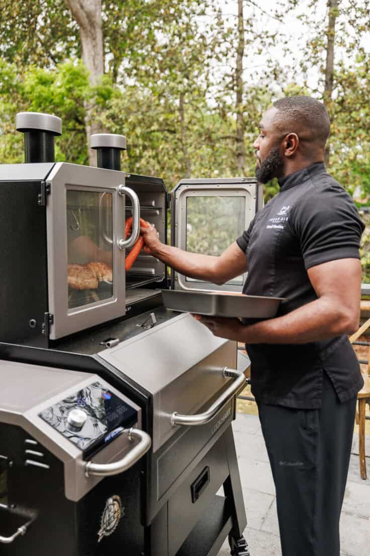 chef trimell place turkey sausages in the smoker.