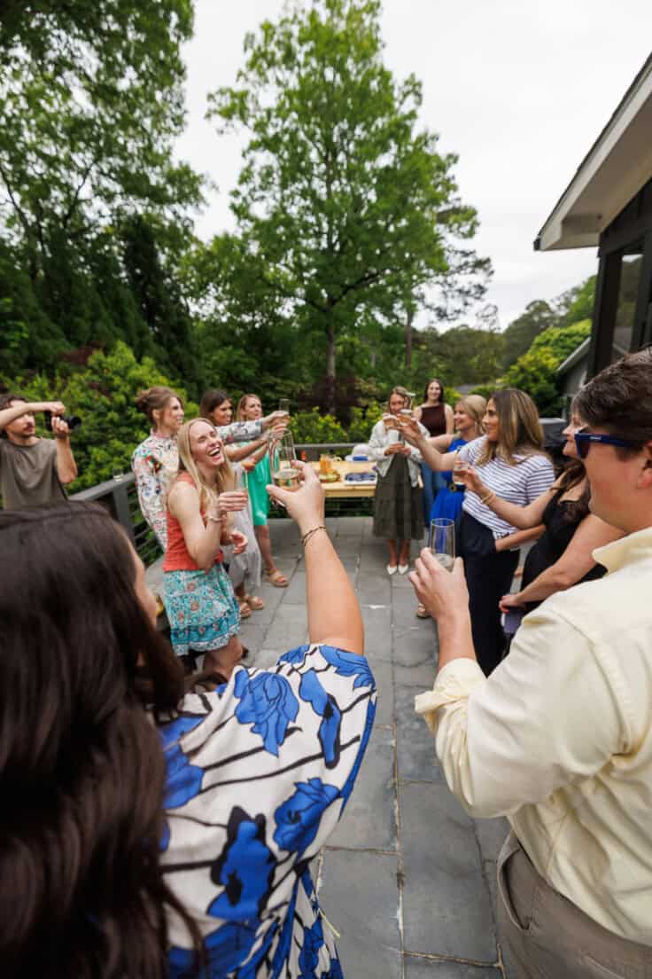 group of food bloggers toasting on patio.
