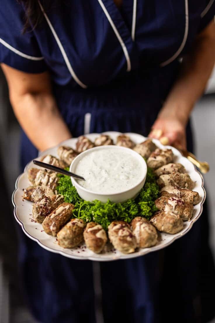 turkey kofta on a white plate with dip.