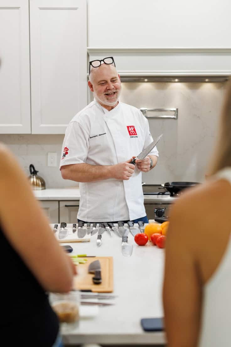 chef talking while holding a knife.