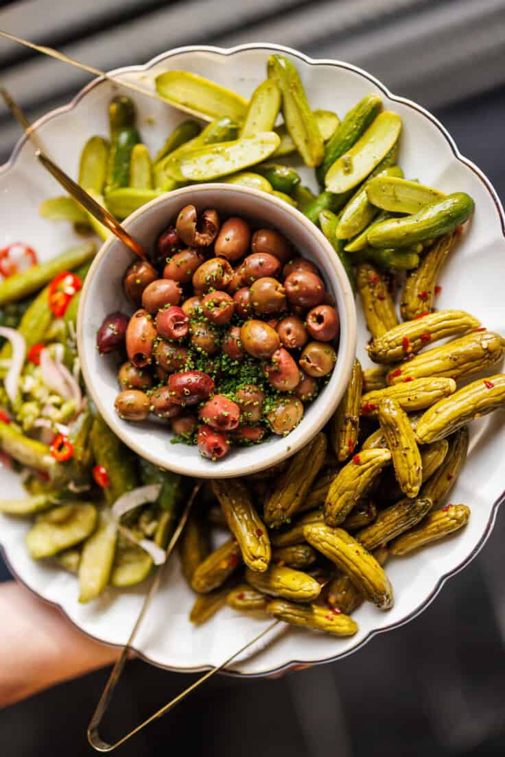 pickles and olives on a serving platter.