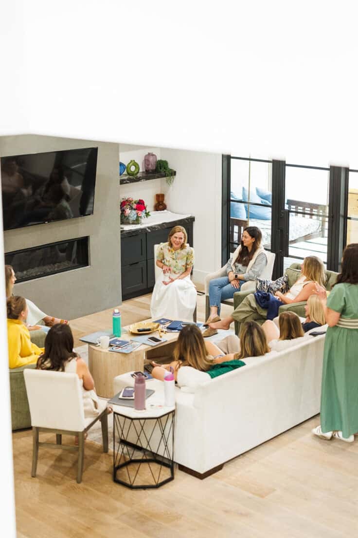 group of women sitting in a living room.