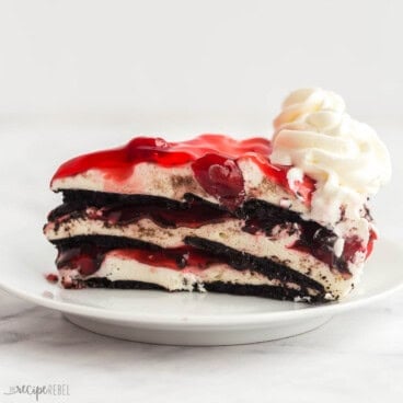 square image of black forest icebox cake with whipped cream on top.