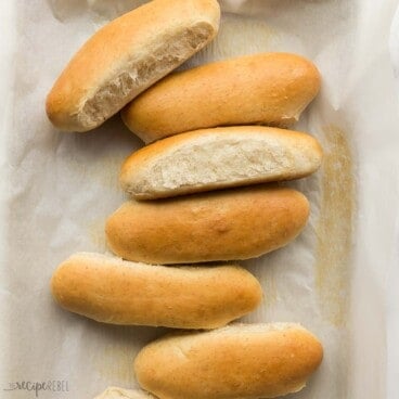 square overhead image of homemade hot dog buns on a parchment lined baking sheet.