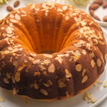 a whole new years almond pound cake on a white plate.